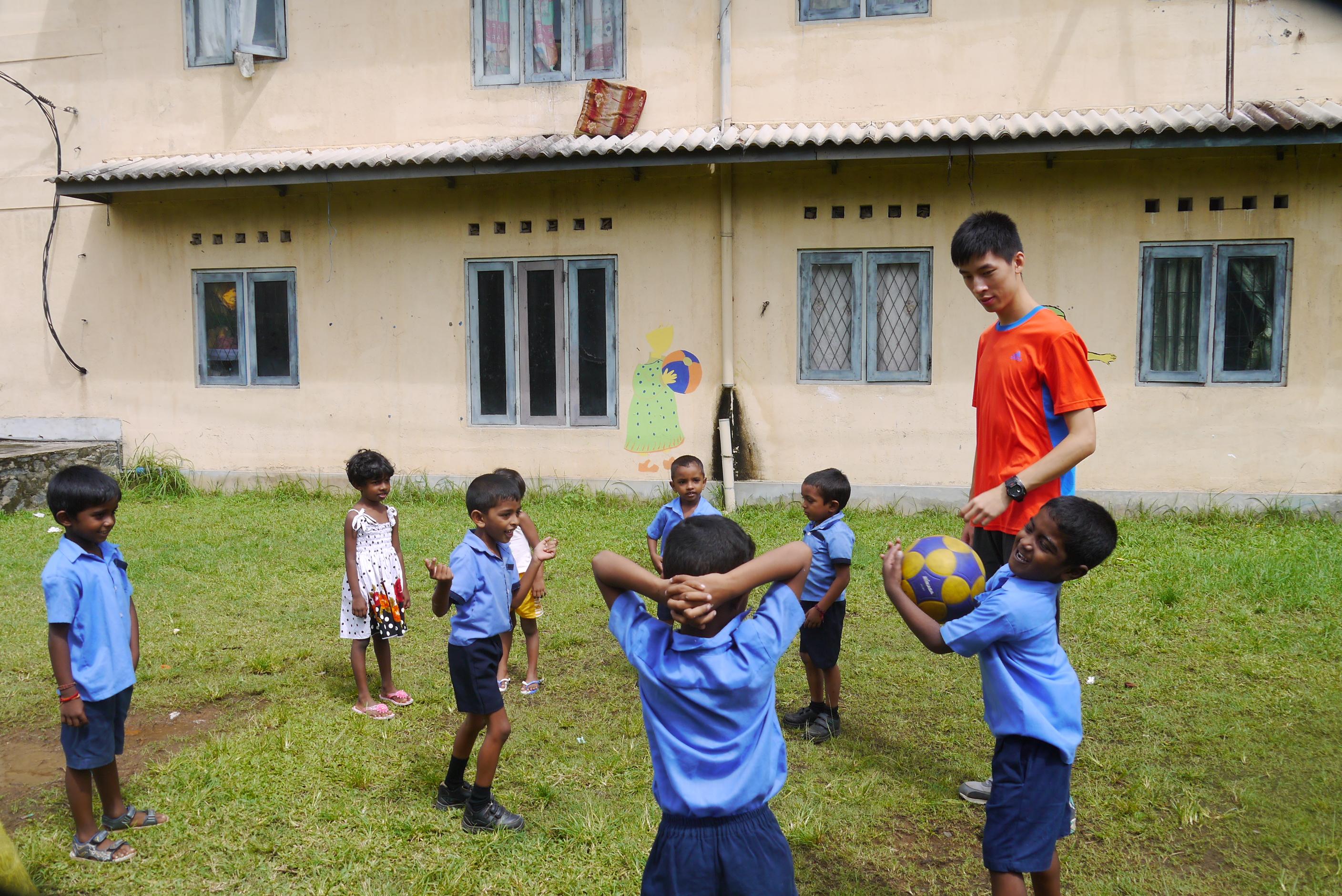 A Projects Abroad volunteer works as a sports coach with young students in schools in Sri Lanka A volunteer coaching sports in schools in Sri Lanka plays a ball game with students